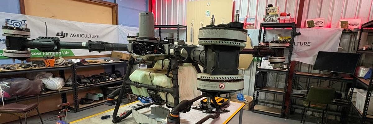 An Agras spray drone stripped down on the workbench at the AGX service centre